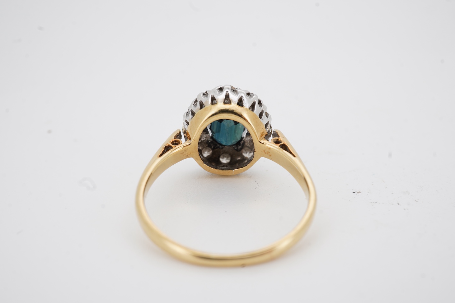 A mid 20th century 18ct and plat, sapphire and diamond set oval cluster ring, size K, gross weight 2.9 grams.